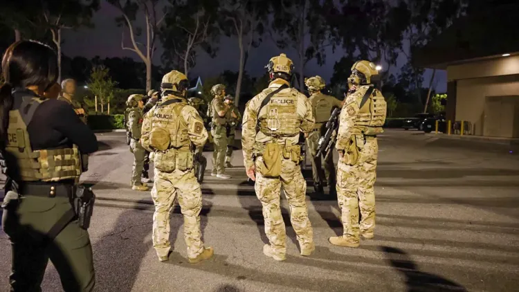 Federal agents stand on a street in Irvine