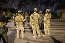 Federal agents stand on a street in Irvine